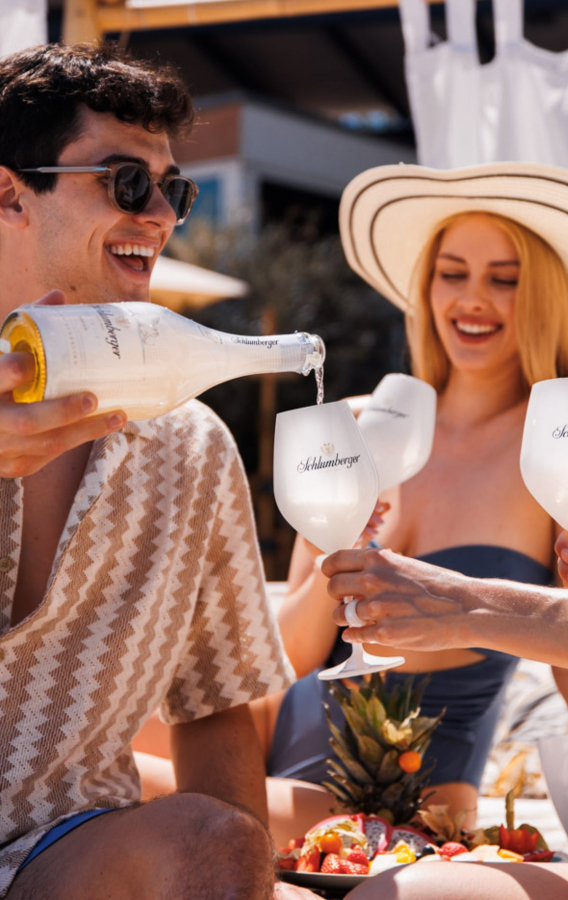 Freunde sitzen in der Sonne und trinken Ice Secco